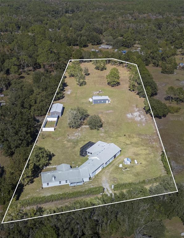 An aerial view shows a house with a pool and outbuildings on a large lot — 2525 RANCHLAND ACRES ROAD, LAKELAND, FL