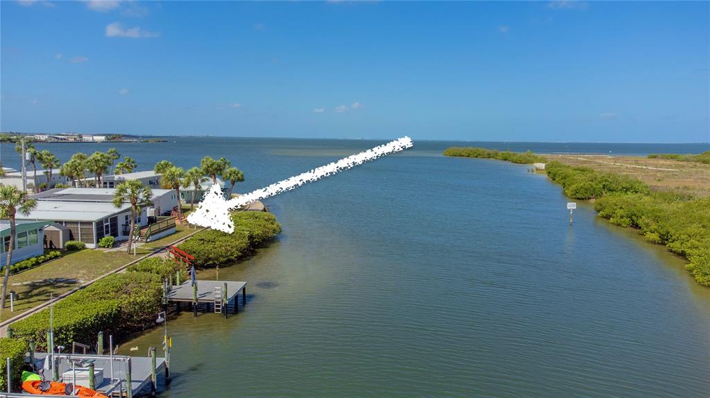 An aerial view shows a waterfront mobile home with a private dock and mangroves — 4851 W GANDY BOULEVARD UNIT 23C, TAMPA, FL
