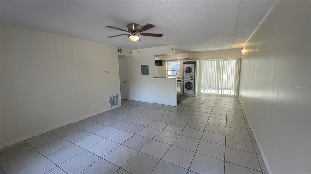 An open-concept living area features light-colored floor tiles, a ceiling fan, and a kitchen nook — 2800 E 113TH AVENUE UNIT B2113, TAMPA, FL
