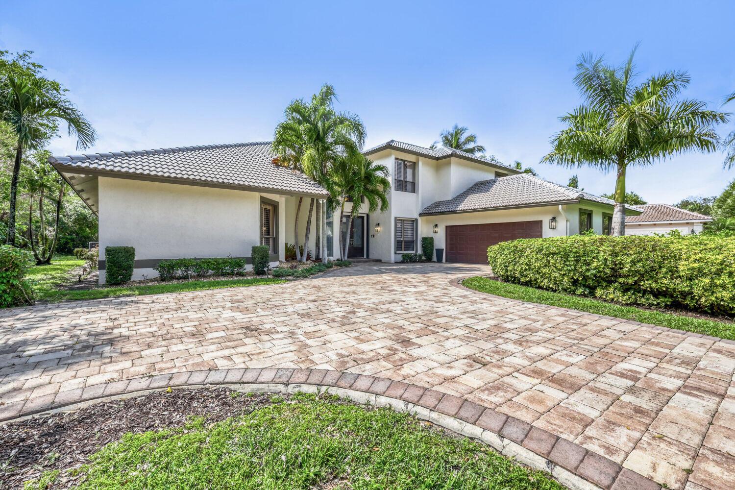 A two-story house with a paved driveway, palm trees, and a large hedge — 10273 St Andrews Road, Boynton Beach FL 33436, BOYNTON BEACH, FL