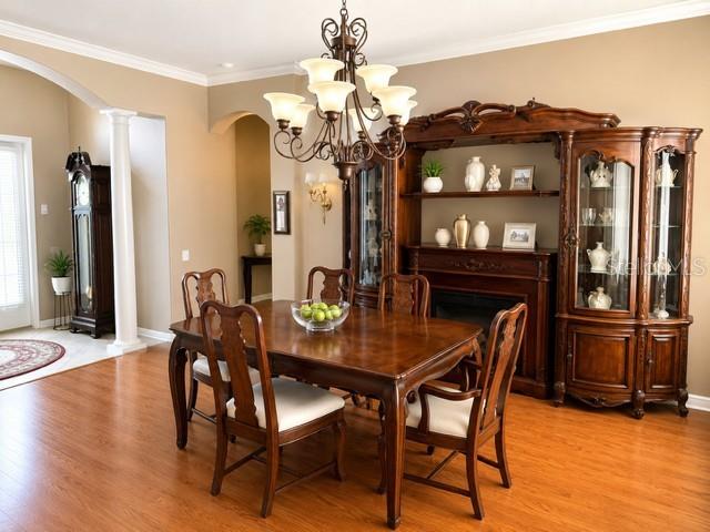 A kitchen features wood cabinets, granite countertops, a center island, and stainless steel appliances — 2021 BLUE BEECH COURT, TRINITY, FL