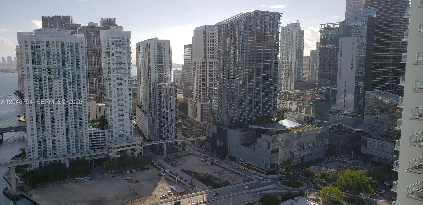 An elevated exterior view of a dense urban skyline featuring multiple high-rise apartment buildings — 90 SW 3rd St # 3710, Miami FL 33130, MIAMI, FL