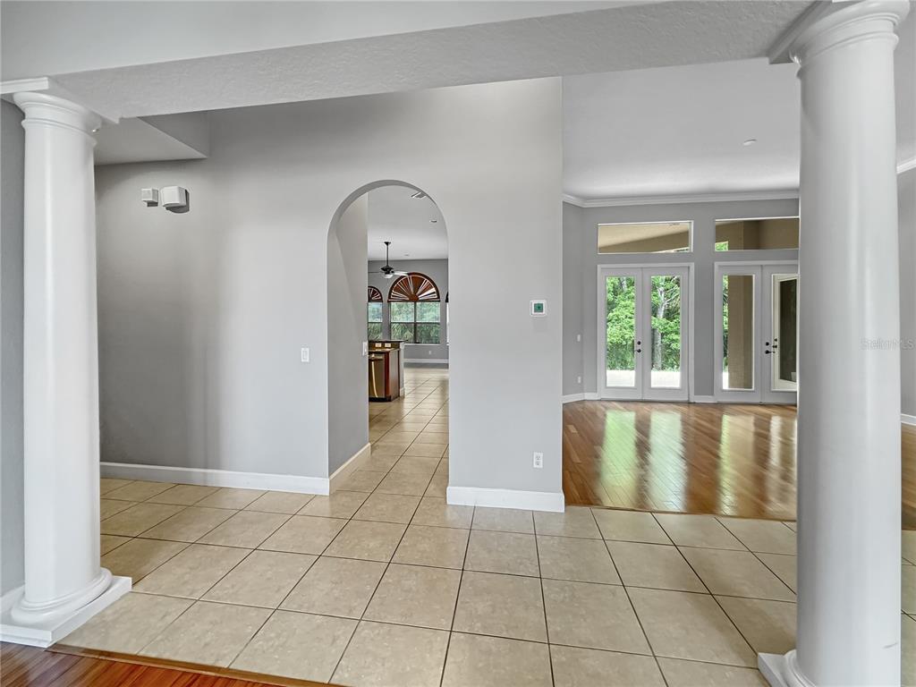 An interior view shows a tiled foyer with white columns leading to a living area — 2770 REGAL PINE TRAIL, OVIEDO, FL