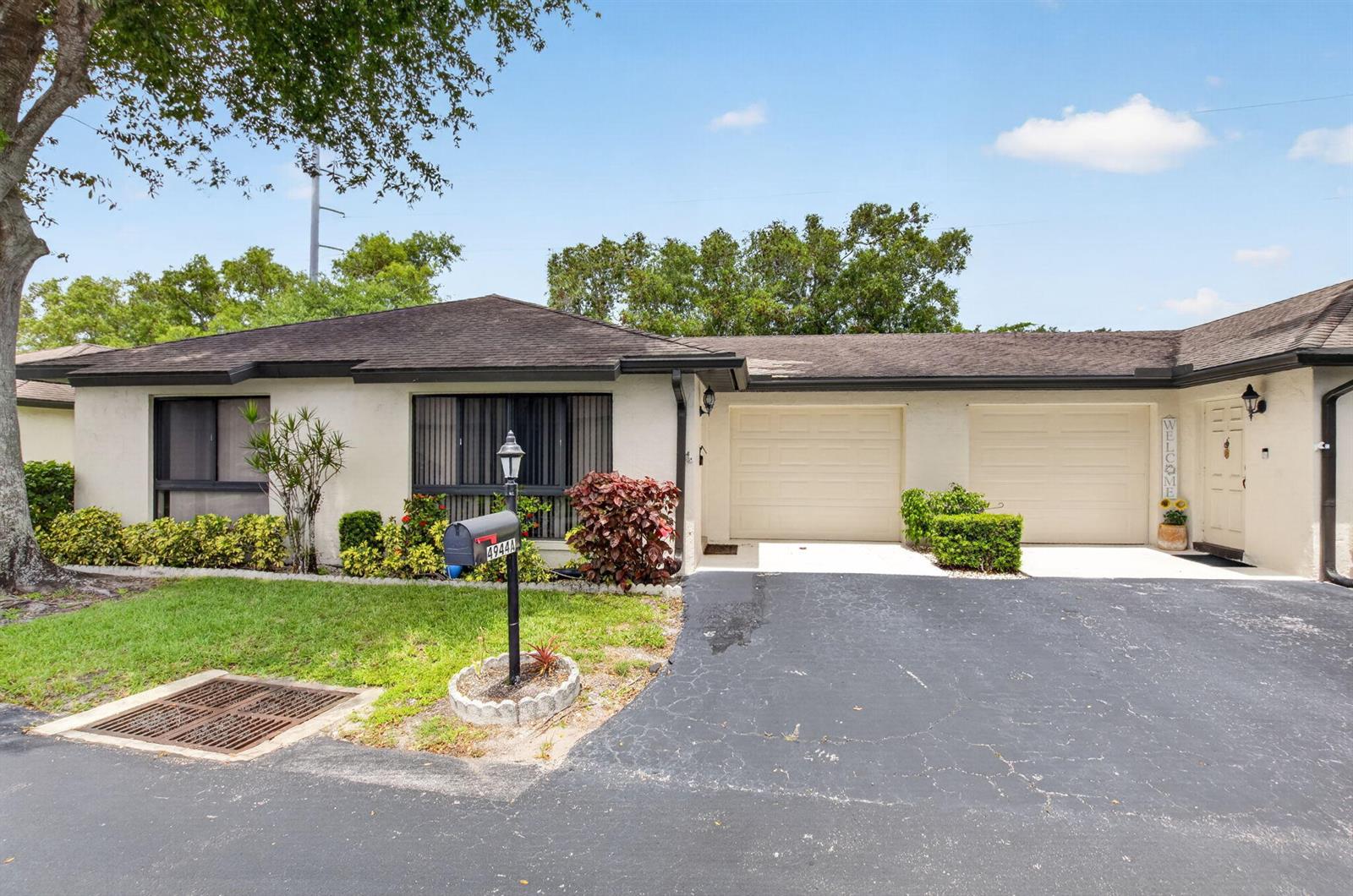 A single-story house with a two-car garage, a mailbox, and a paved driveway — 4944 Equestrian Circle # A, Boynton Beach FL 33436, BOYNTON BEACH, FL