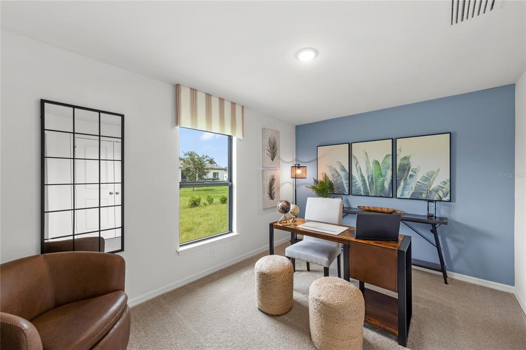 A home office features a blue accent wall, a desk, a chair, and a window — 575 W DUQUET PLACE, CITRUS SPRINGS, FL