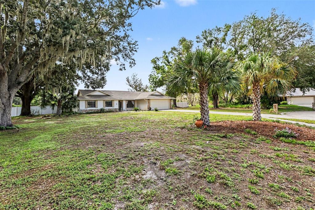A swimming pool sits on a patio enclosed by a large screen structure — 4504 DEER PARK PLACE, BRANDON, FL