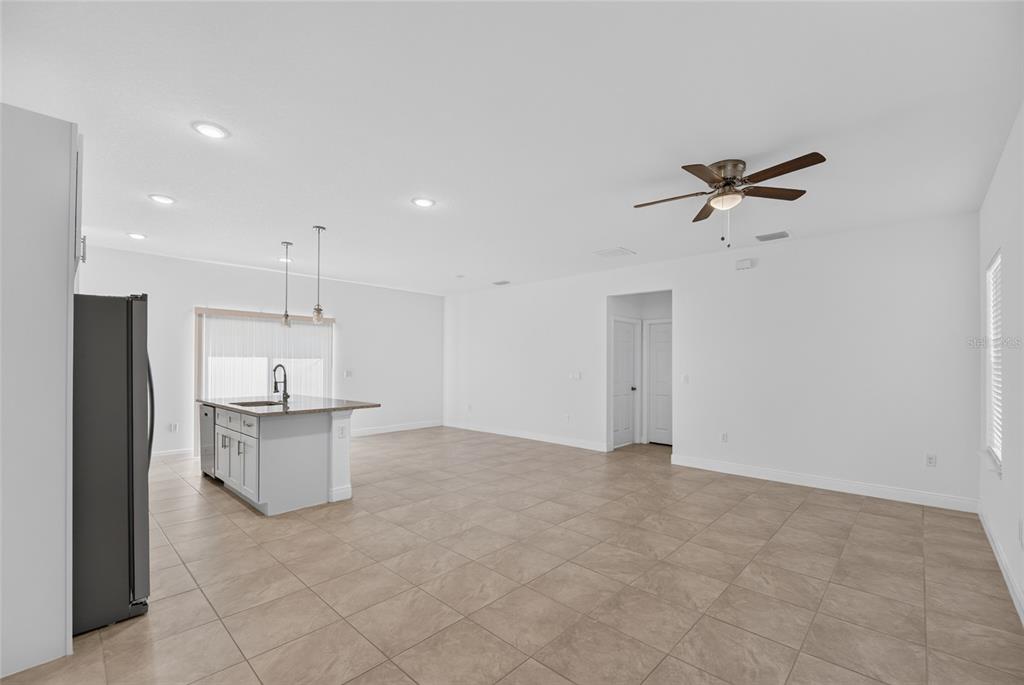 An open-concept kitchen and living area featuring tile flooring, a center island, and recessed lighting — 15475 SW 23RD AVENUE ROAD, OCALA, FL
