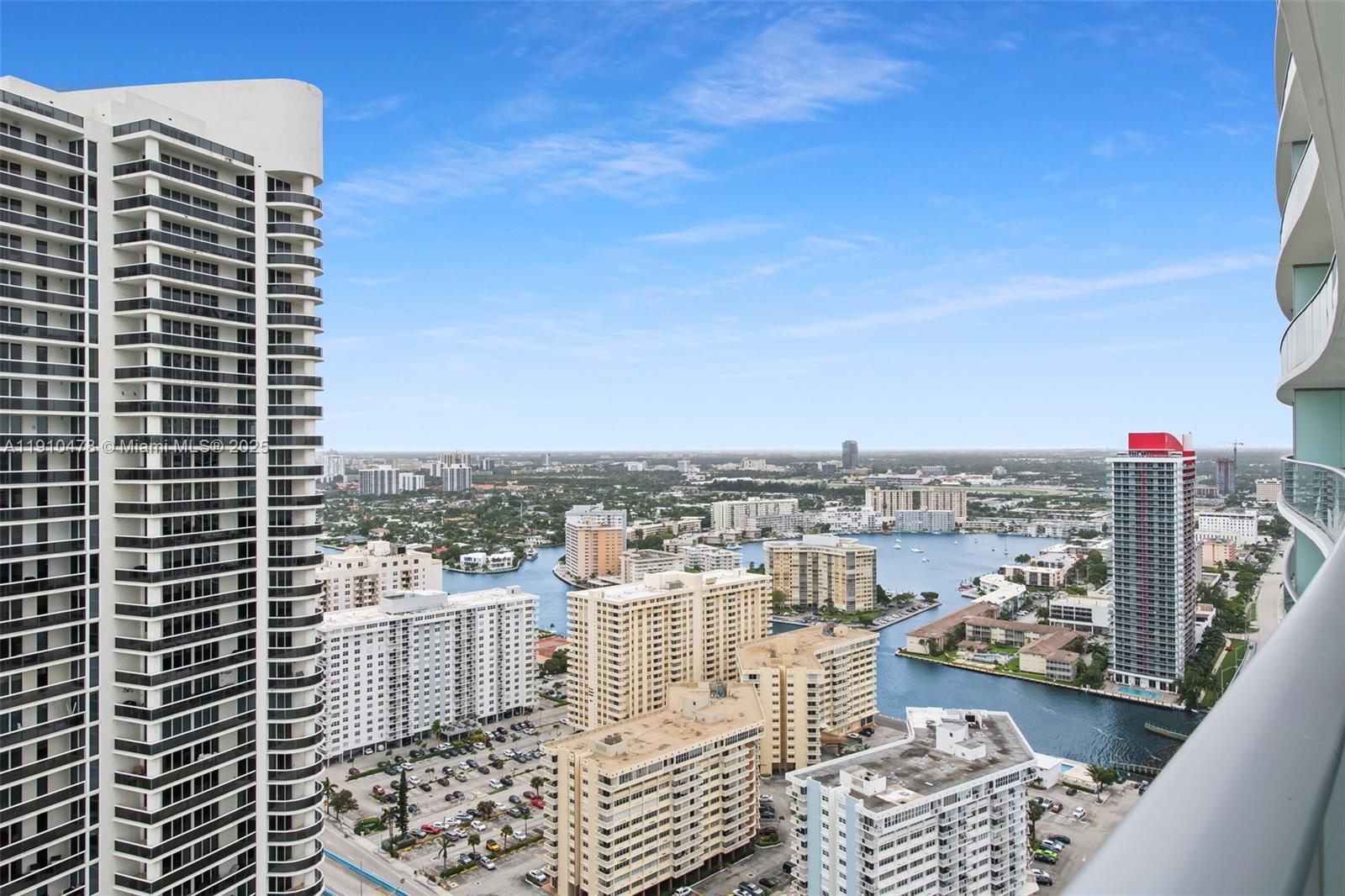 An elevated view shows multiple high-rise apartment buildings surrounding a waterway in a city — 4111 S Ocean Dr # 3001, Hollywood FL 33019, HOLLYWOOD, FL