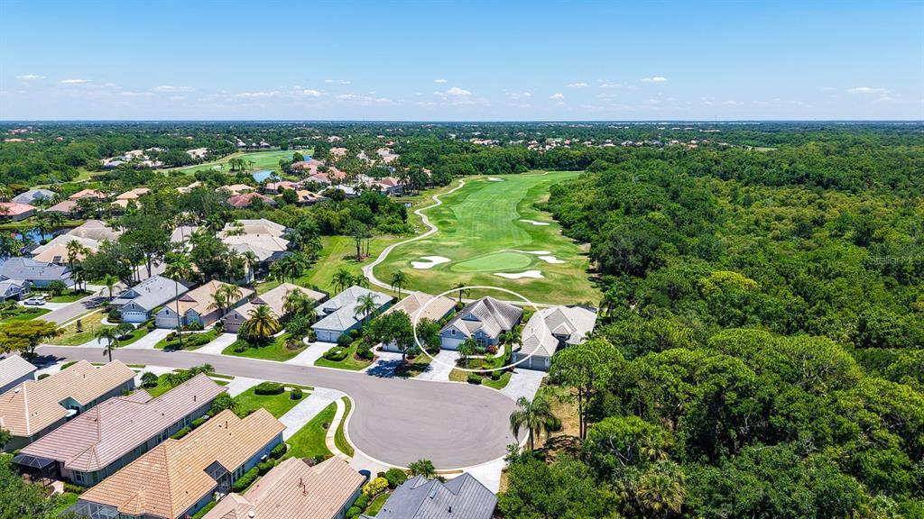 An aerial view shows a residential house circled in a neighborhood bordering a golf course — 7823 HERITAGE CLASSIC COURT, LAKEWOOD RANCH, FL
