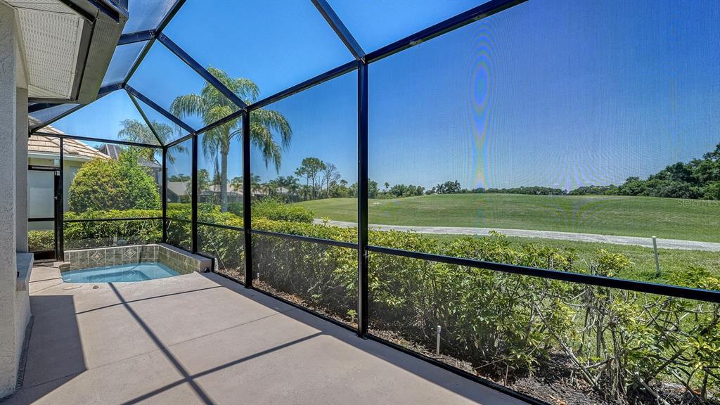 A screened-in patio features a small pool and views of a grassy golf course — 7823 HERITAGE CLASSIC COURT, LAKEWOOD RANCH, FL