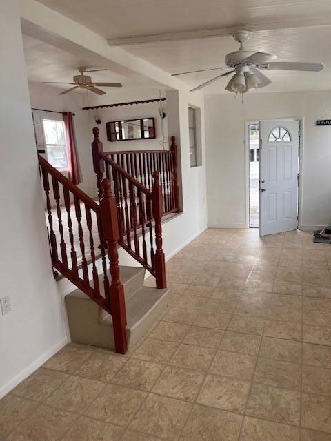 A room with tiled floors, a wooden staircase, and two ceiling fans — 4149 88th Court S, Boynton Beach FL 33436, BOYNTON BEACH, FL