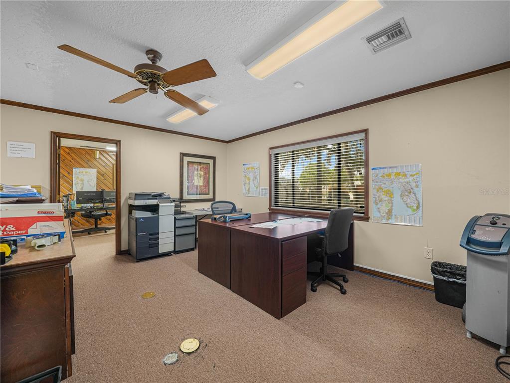 An office with a desk, printer, ceiling fan, and a window with blinds — 112 N POPLAR AVENUE, SANFORD, FL