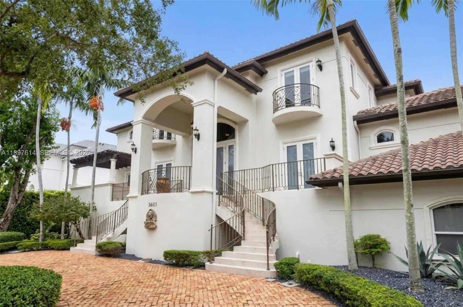 A two-story stucco house with a curved staircase, wrought iron railings, and a tiled roof — 3601 Matheson Ave, Miami FL 33133, MIAMI, FL