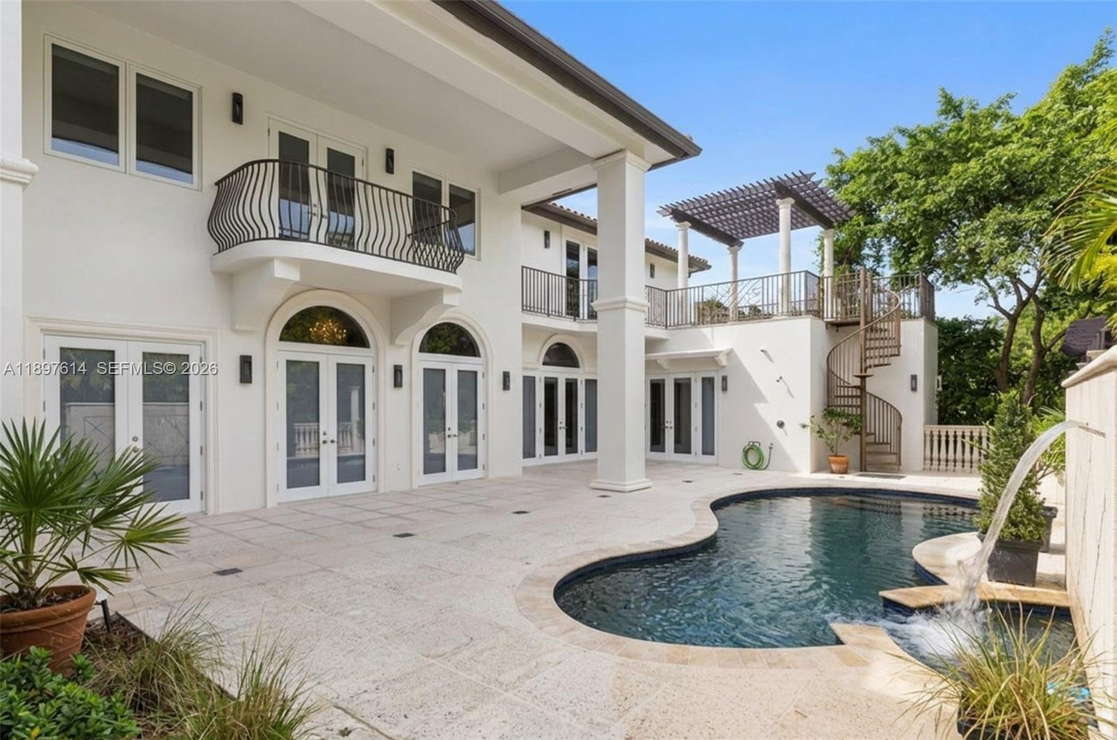 A white two-story house features a curved balcony, a spiral staircase, and a backyard pool — 3601 Matheson Ave, Miami FL 33133, MIAMI, FL