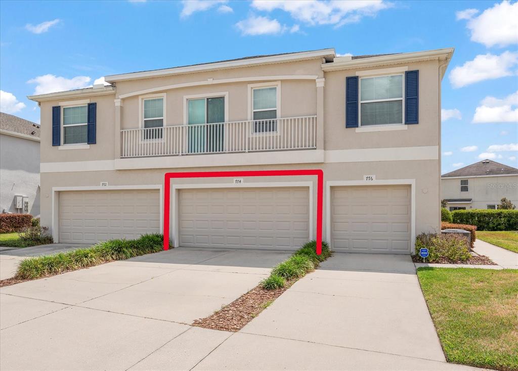 A two-story beige townhouse exterior features two front entrances with small gabled porches — 774 ASHENTREE DRIVE, PLANT CITY, FL