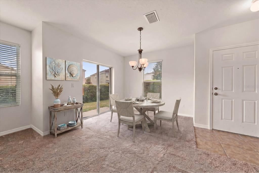 A living room features a staircase, a television console, a sofa, and an armchair — 774 ASHENTREE DRIVE, PLANT CITY, FL