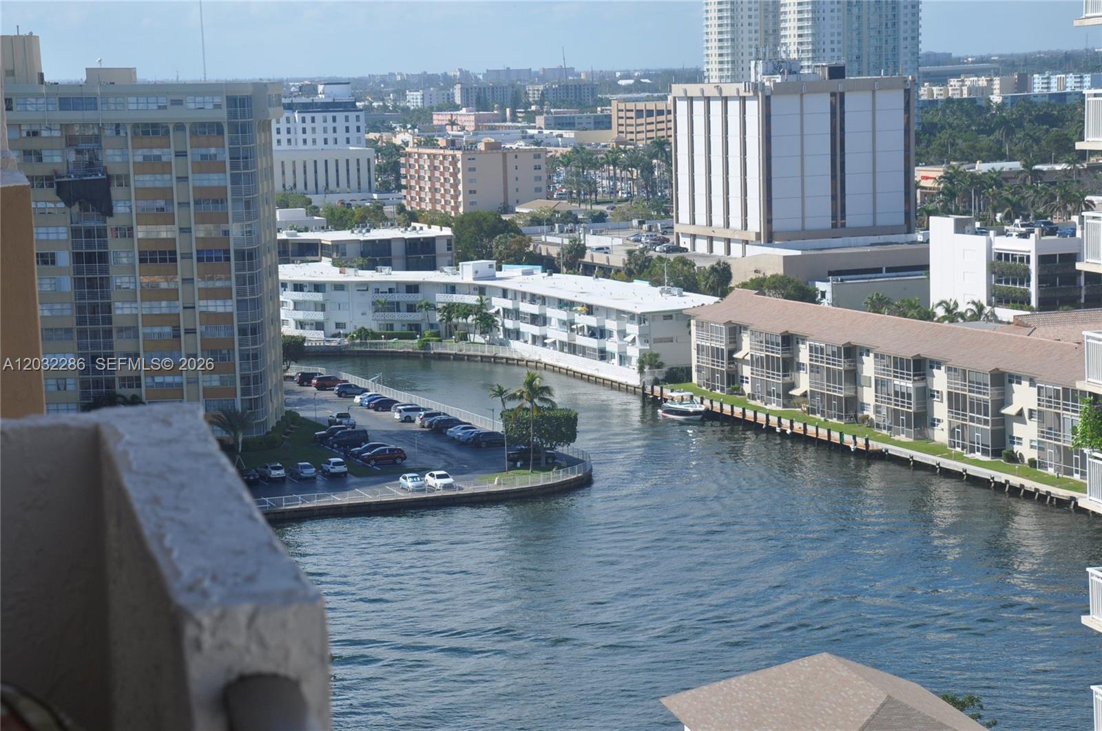 An elevated view shows a canal, parking lot, and surrounding residential buildings — 1865 S Ocean Dr # 12E, Hallandale Beach FL 33009, HALLANDALE BEACH, FL