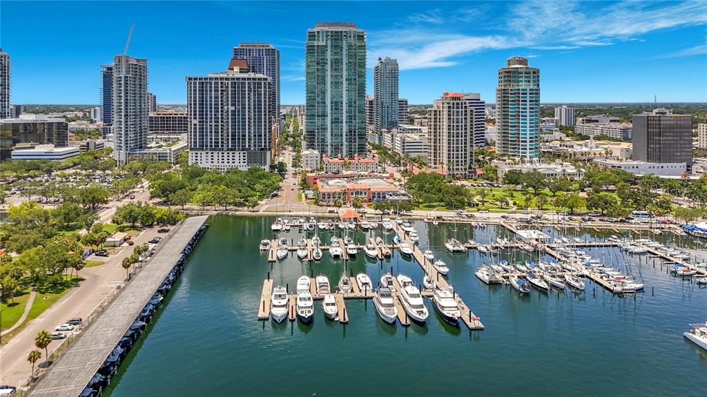 An aerial view shows a marina with many docked boats in front of city skyscrapers — 100 1ST AVENUE N UNIT 1106, ST PETERSBURG, FL