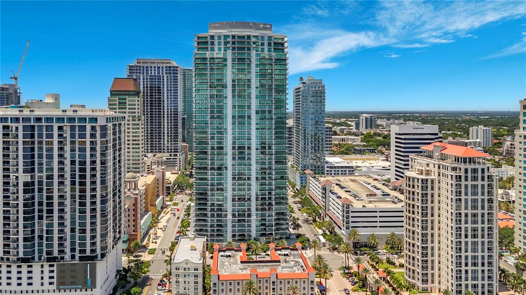 An aerial view shows several tall, modern residential and commercial buildings in a city — 100 1ST AVENUE N UNIT 1106, ST PETERSBURG, FL