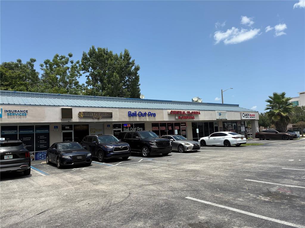 A single-story commercial strip mall with multiple storefronts and a parking lot in front — 2911 39TH STREET UNIT 200, ORLANDO, FL