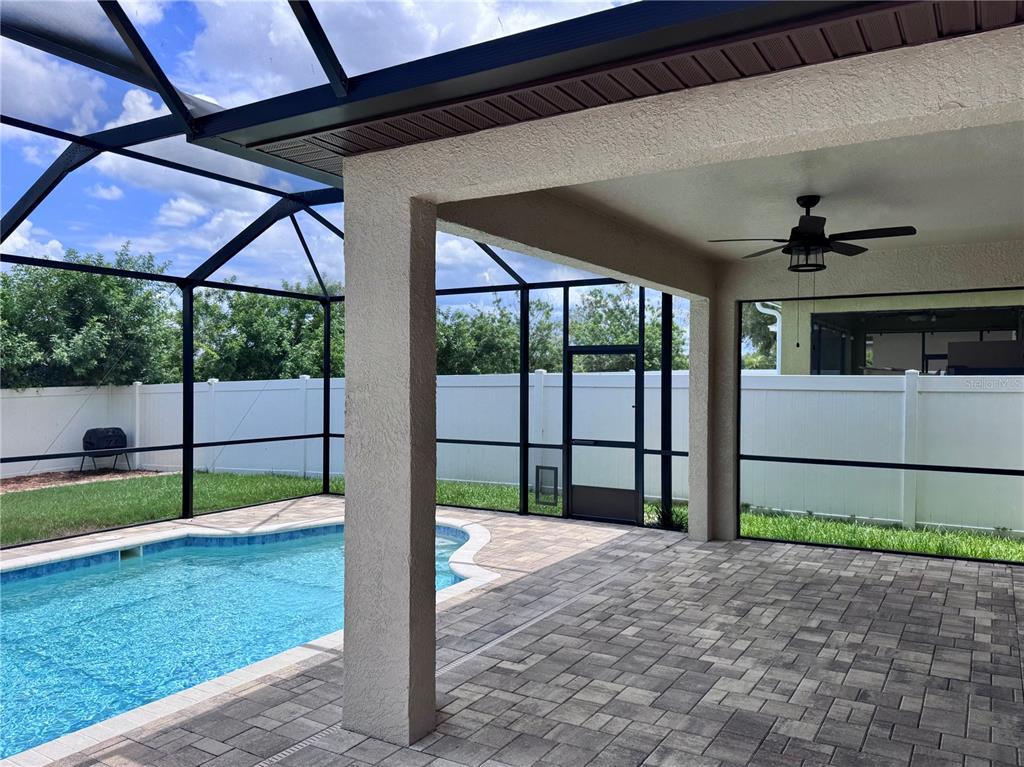 A living room features wood-look tile flooring, a fireplace with built-in shelving, and carpeted stairs — 1625 EMERALD HILL WAY, VALRICO, FL