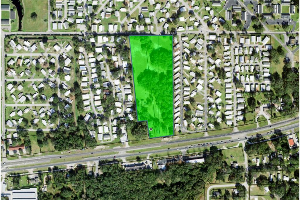 An aerial map view highlights a rectangular, tree-covered vacant lot surrounded by residential mobile homes — 4011 S ORANGE BLOSSOM TRAIL, KISSIMMEE, FL