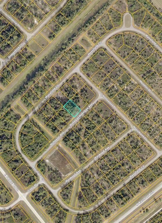 This is an aerial map showing a vacant lot highlighted in blue within a residential neighborhood — 000 MOHEGAN AVENUE, NORTH PORT, FL