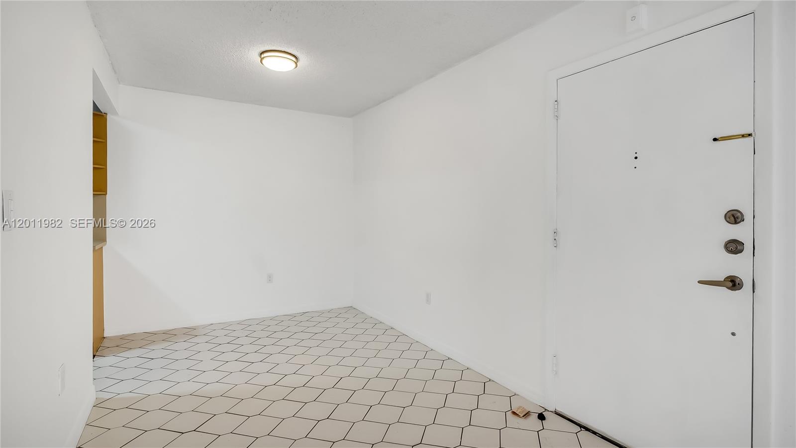 An empty room features white walls, a tiled floor, and a white entry door — 7231 Miami Lakes Dr # C5, Miami Lakes FL 33014, MIAMI LAKES, FL