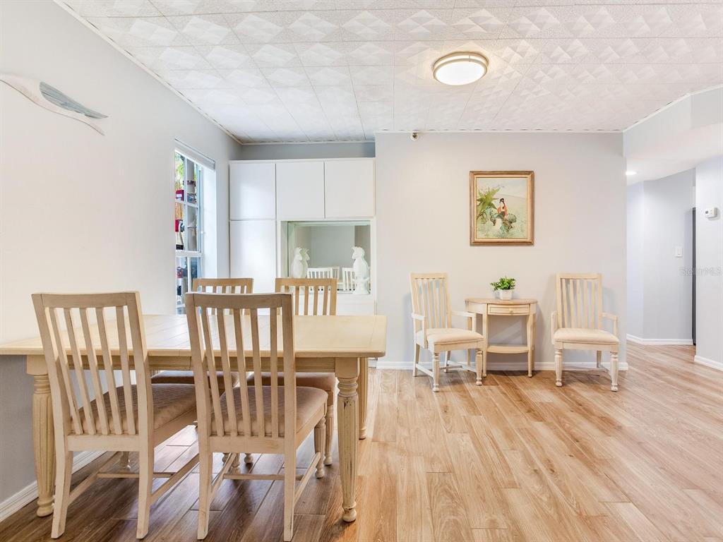 A dining room features light wood flooring, a textured ceiling, and a wooden dining set — 508 S GLEN AVENUE UNIT 2, TAMPA, FL