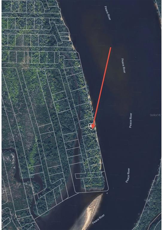 This aerial map shows a residential lot highlighted along the shoreline of the Peace River — 1206 MALABO COURT, PUNTA GORDA, FL