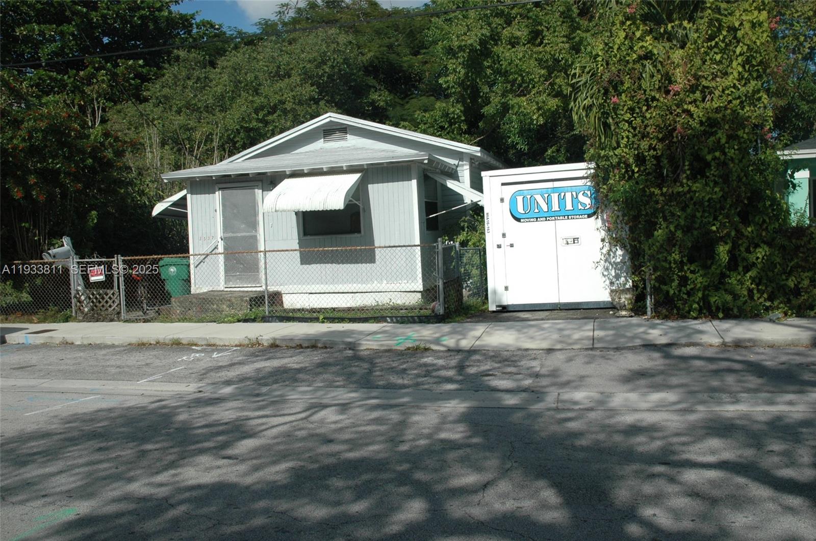 A small, light-gray house with a metal awning and a portable storage unit outside — 3537 Charles Ave, Miami FL 33133, MIAMI, FL