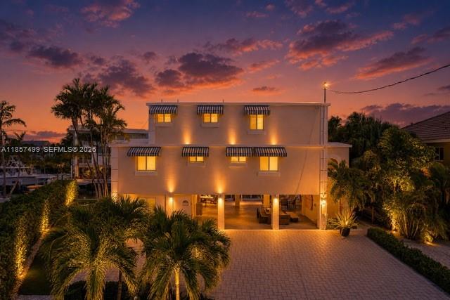 An aerial view shows a house with a 90-foot deepwater dock and a boat — 122 Court Contessa, Islamorada FL 33036, ISLAMORADA, FL