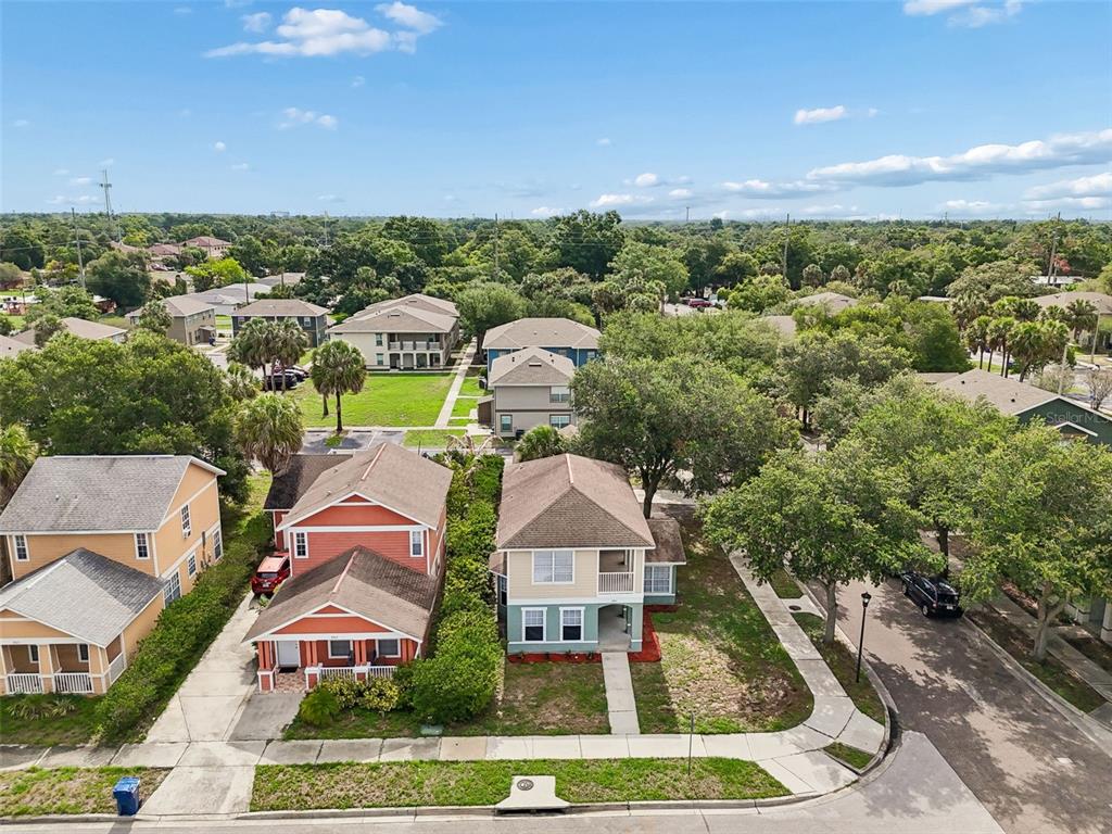 An aerial view shows two adjacent houses with driveways and lawns in a suburban neighborhood — 3801 MACHADO STREET, TAMPA, FL