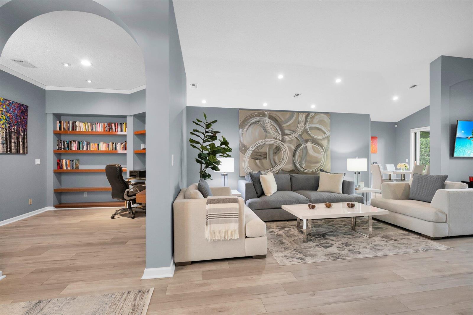 A living room with light wood floors, gray walls, and a built-in office nook — 10393 Lexington Circle S, Boynton Beach FL 33436, BOYNTON BEACH, FL
