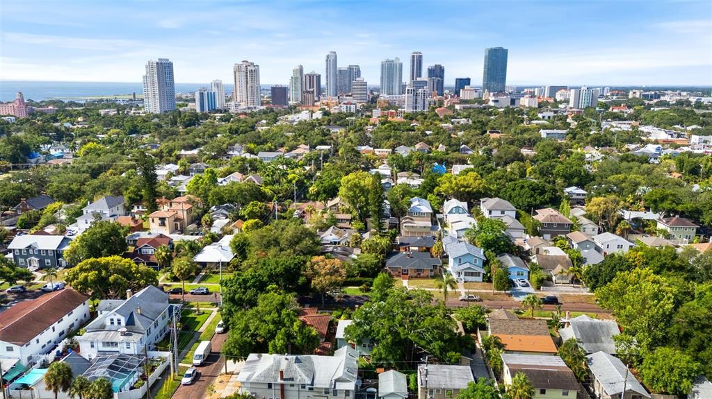 An aerial view of a residential neighborhood with a city skyline in the background — 205 12TH AVENUE N, ST PETERSBURG, FL