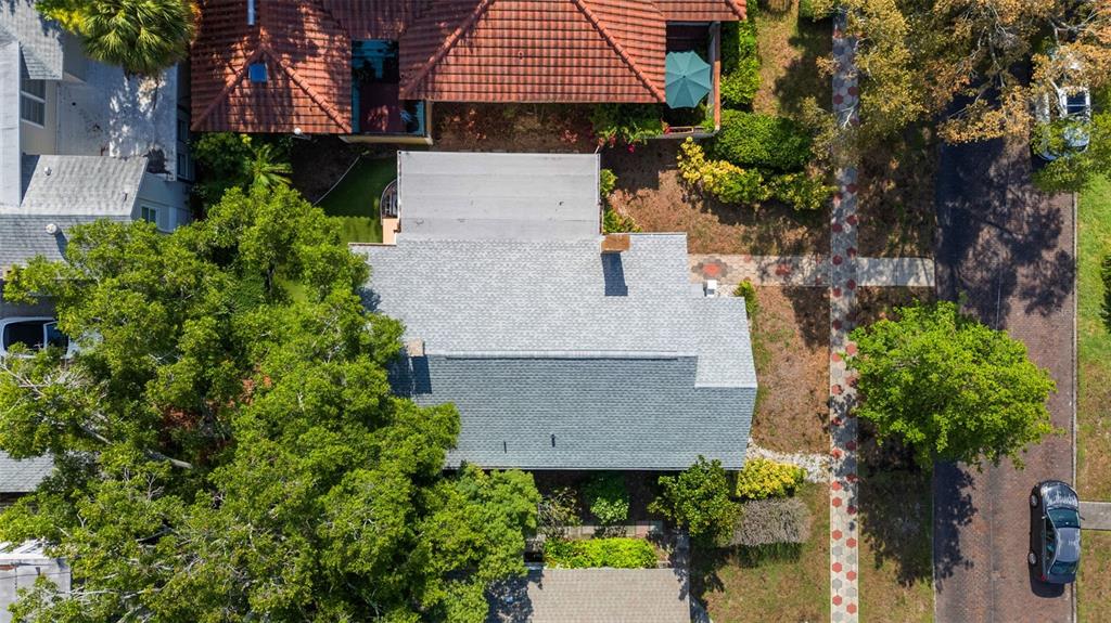 An aerial view shows a house with a gray shingled roof and a brick walkway — 205 12TH AVENUE N, ST PETERSBURG, FL