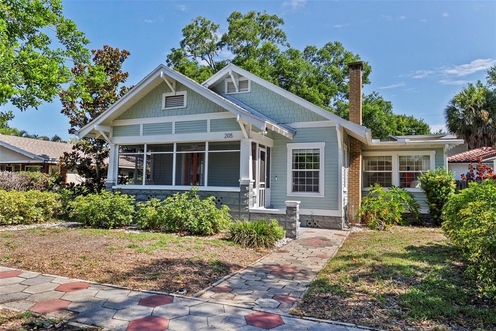 A light green bungalow with a screened front porch and a brick chimney — 205 12TH AVENUE N, ST PETERSBURG, FL