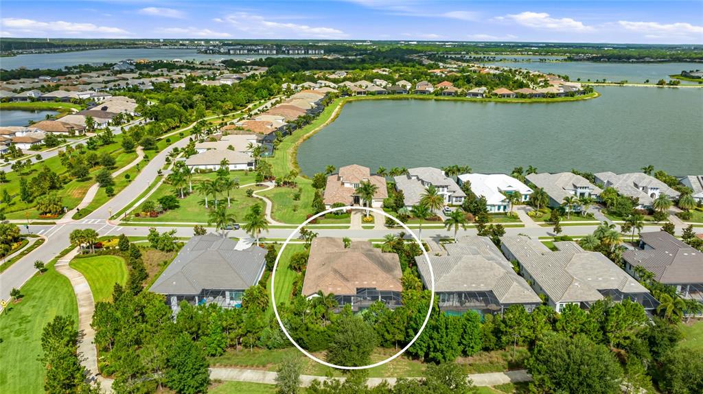 A single-story house with a tiled roof, beige stucco exterior, and a paved driveway — 804 CROSSWIND AVENUE, SARASOTA, FL