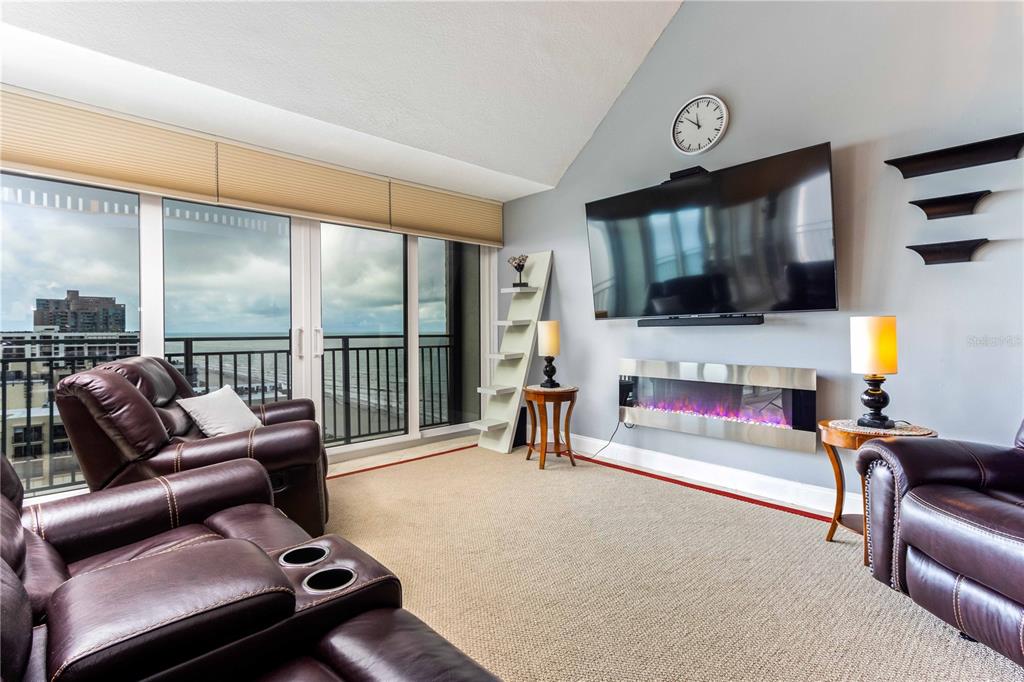 A living area with light tile floors, gray walls, and a small seating area — 1390 GULF BOULEVARD UNIT PH-3, CLEARWATER BEACH, FL