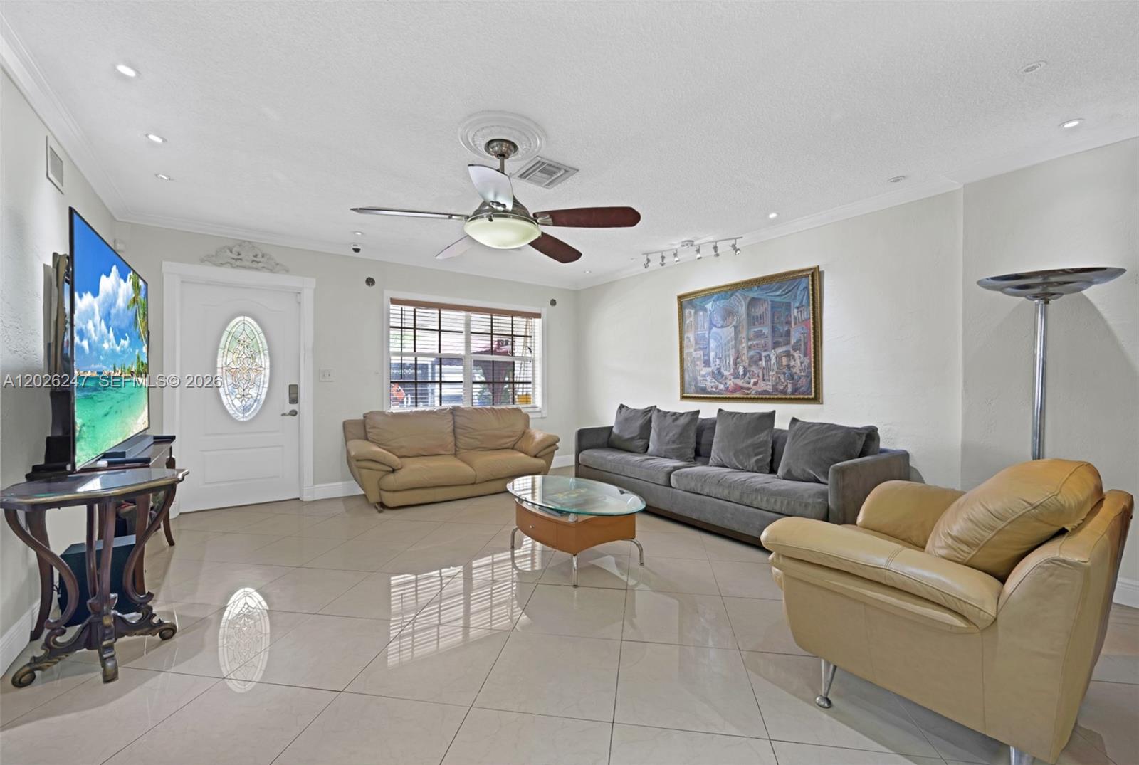 A living room features light tile floors, a ceiling fan, and two sofas — 2849 Dewey St # 2849, Hollywood FL 33020, HOLLYWOOD, FL