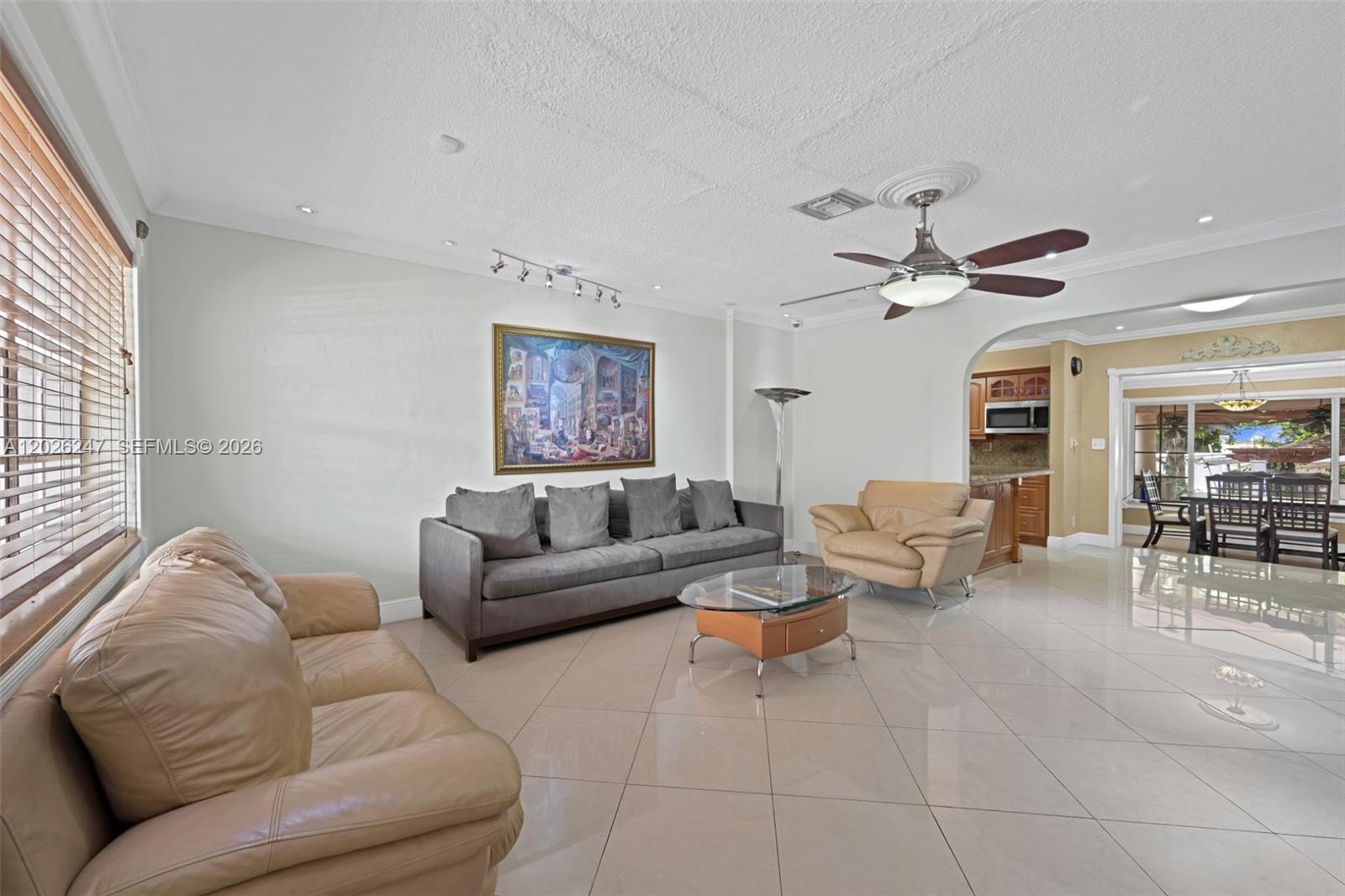 A living room features light tile floors, a gray sofa, and tan leather seating — 2849 Dewey St # 2849, Hollywood FL 33020, HOLLYWOOD, FL