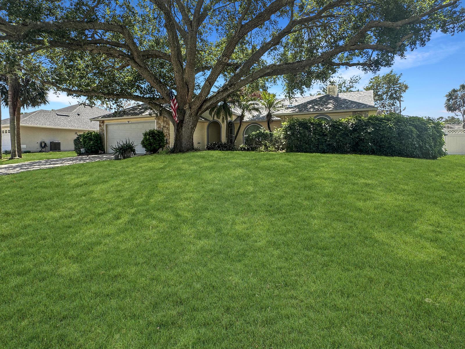A single-story house with a large oak tree in the front yard and green lawn — 117 Hinchman Avenue, Sebastian FL 32958, SEBASTIAN, FL