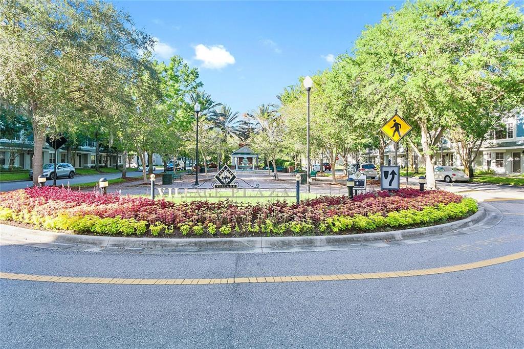 A landscaped roundabout features a West Park Village Plaza sign and a central gazebo — 9597 CAVENDISH DRIVE, TAMPA, FL