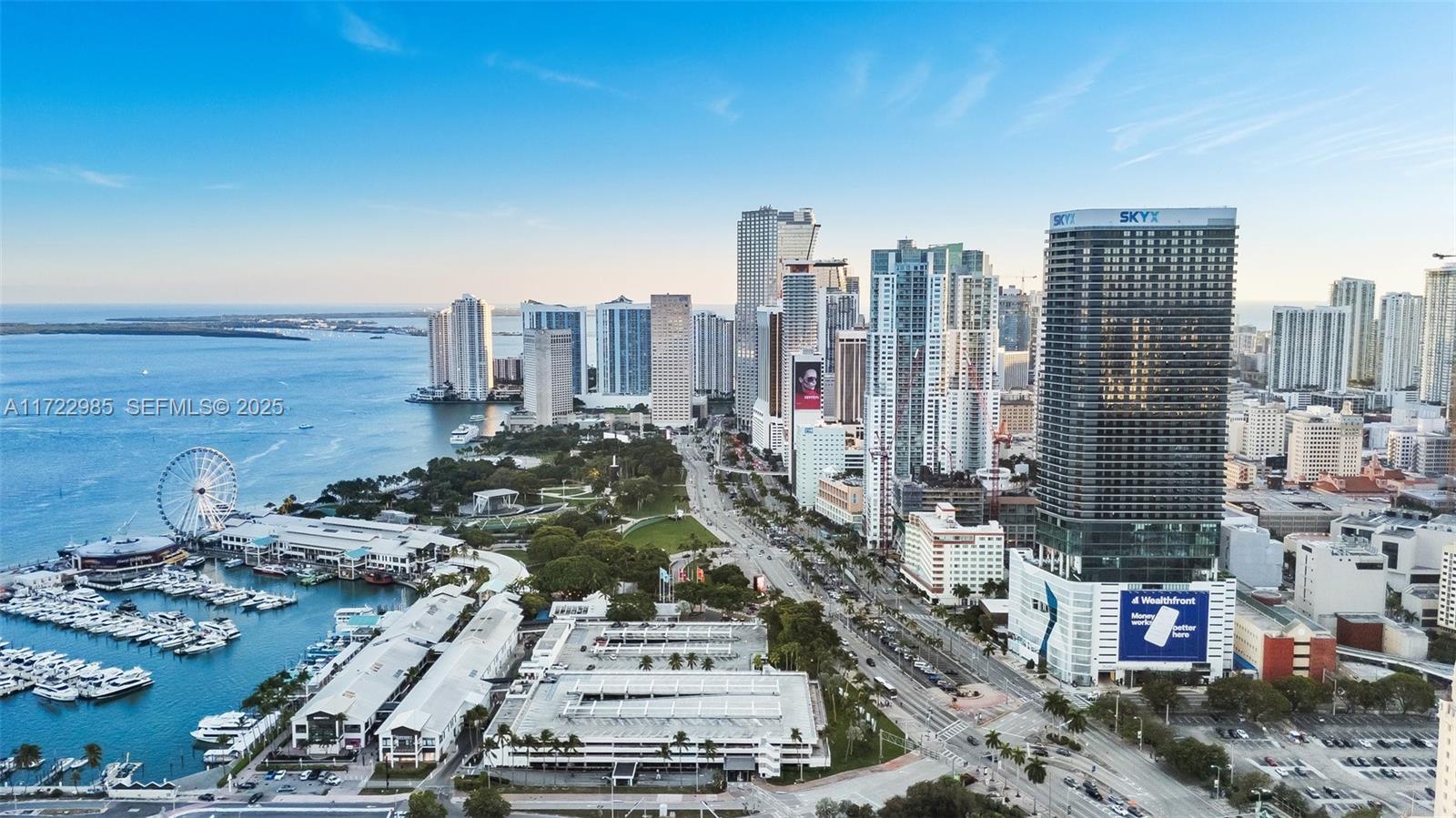 An aerial view shows the Miami skyline, a marina, a Ferris wheel, and coastal buildings — 398 NE 5th St # 3209, Miami FL 33132, MIAMI, FL