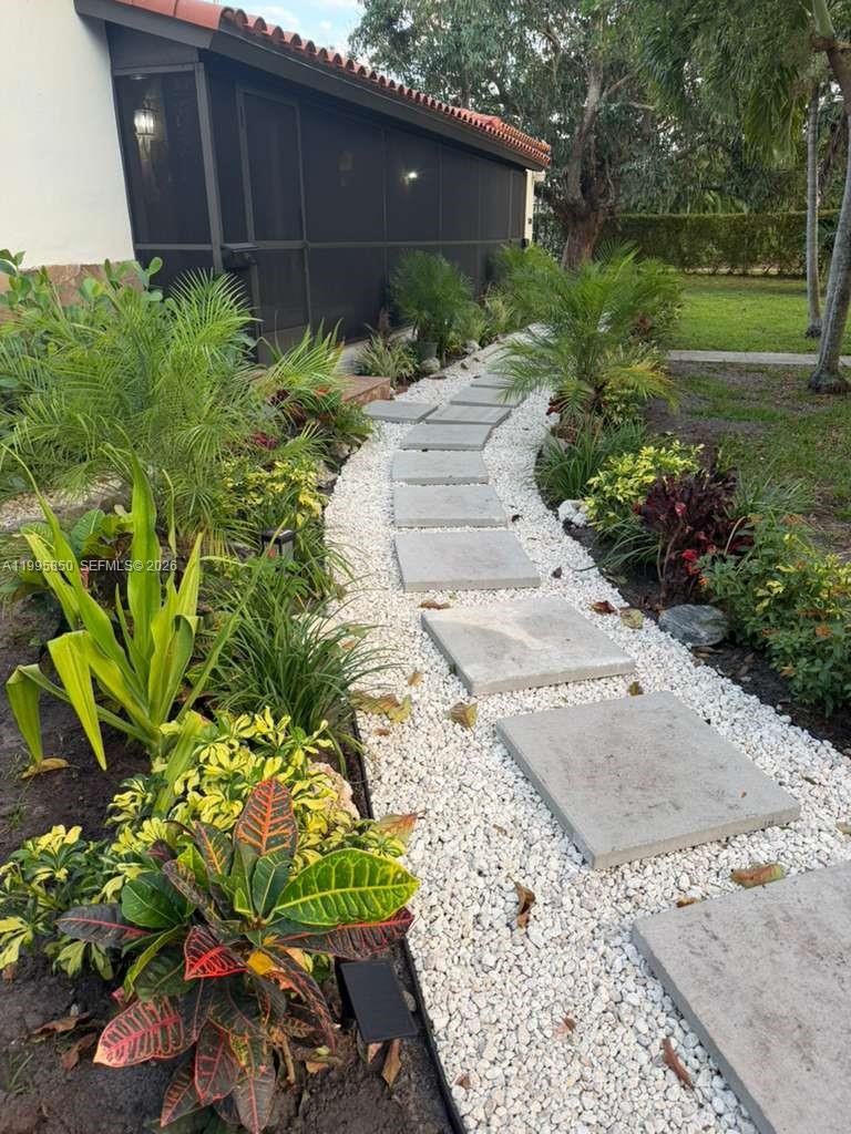 A stone paver walkway winds through a garden bed filled with white gravel and plants — 11201 NE 10th Ave # 11201, Biscayne Park FL 33161, BISCAYNE PARK, FL
