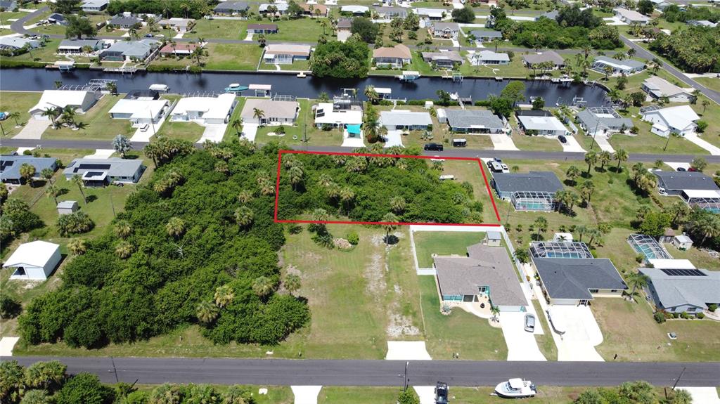 An aerial view shows a rectangular vacant lot outlined in red surrounded by residential houses — 4501 EWING CIRCLE, PORT CHARLOTTE, FL