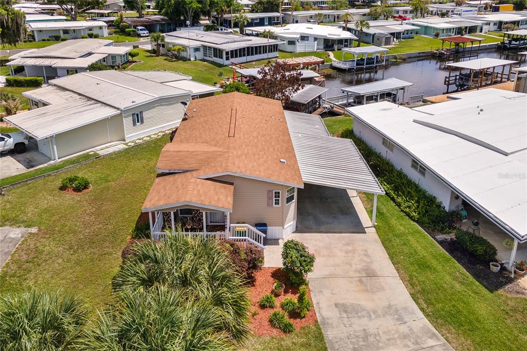 An aerial view shows a single-story mobile home with a brown roof and attached carport — 2417 VINDALE ROAD, TAVARES, FL