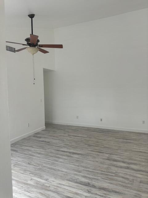 An empty room with light wood-look flooring, white walls, and a ceiling fan — 1171 Summit Trail Circle # C, West Palm Beach FL 33415, WEST PALM BEACH, FL