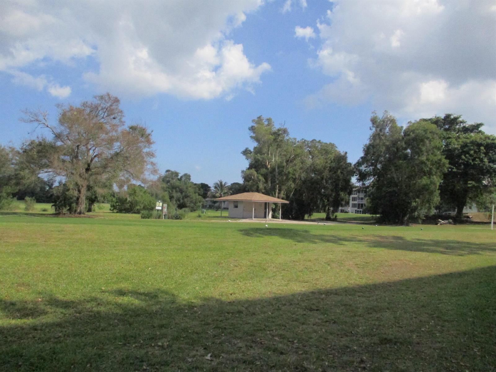 A small, single-story building sits in the middle of a large, grassy park area — 3300 N Palm Aire Drive # 306, Pompano Beach FL 33069, POMPANO BEACH, FL