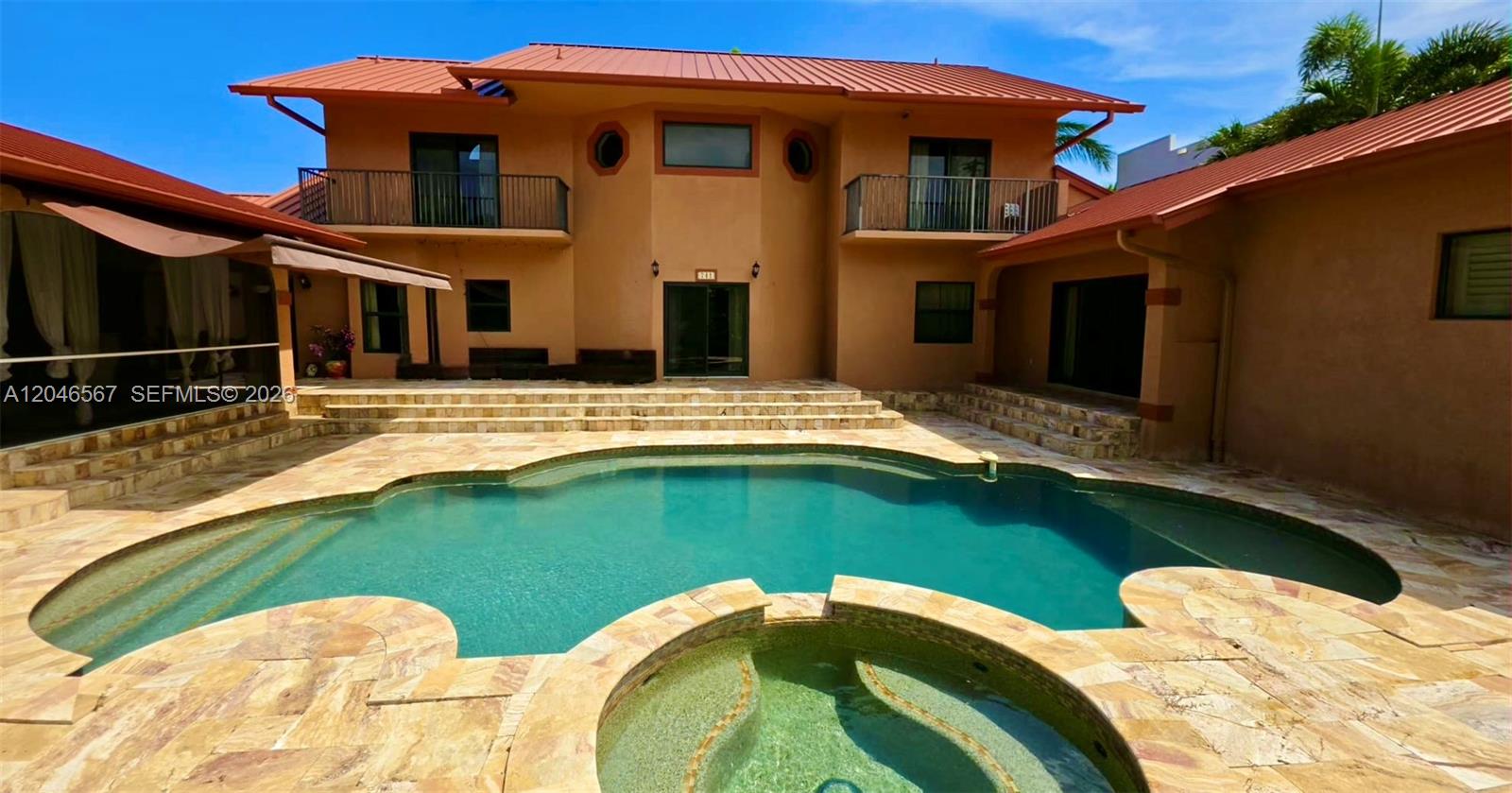 A two-story house with a red metal roof overlooks a swimming pool and spa — 741 Tyler St # 0, Hollywood FL 33019, HOLLYWOOD, FL